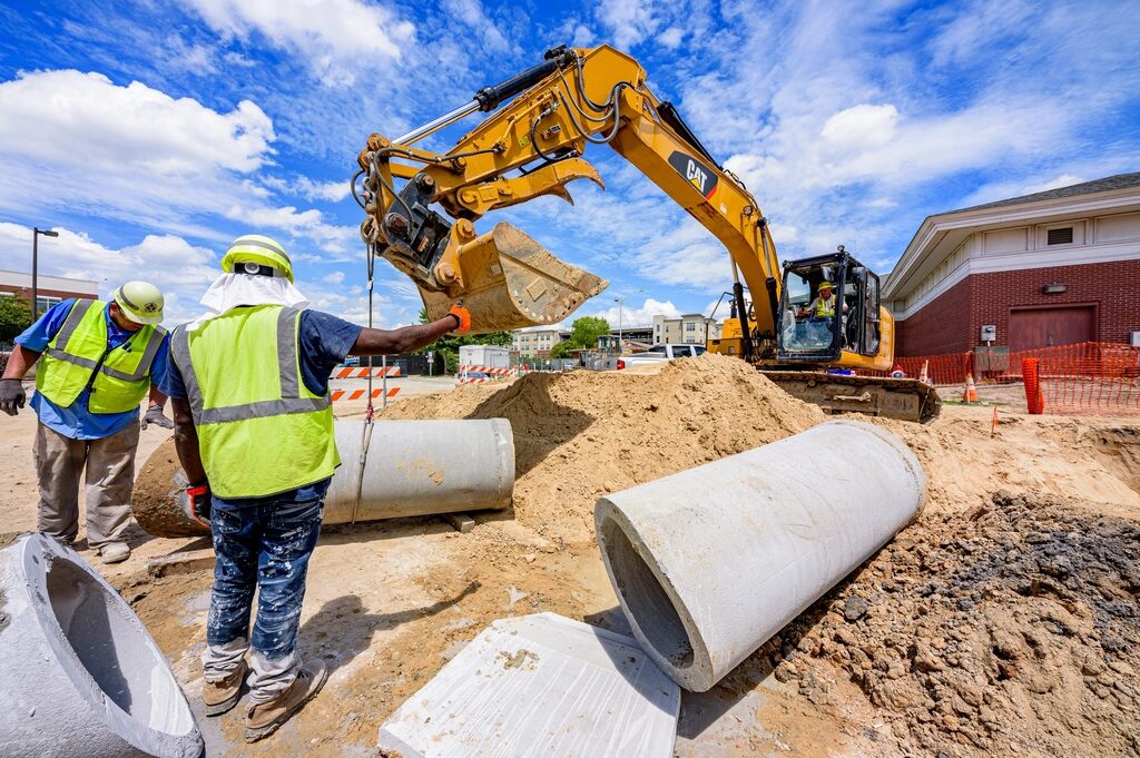 Construction crew in hi-vis at a pipe excavation